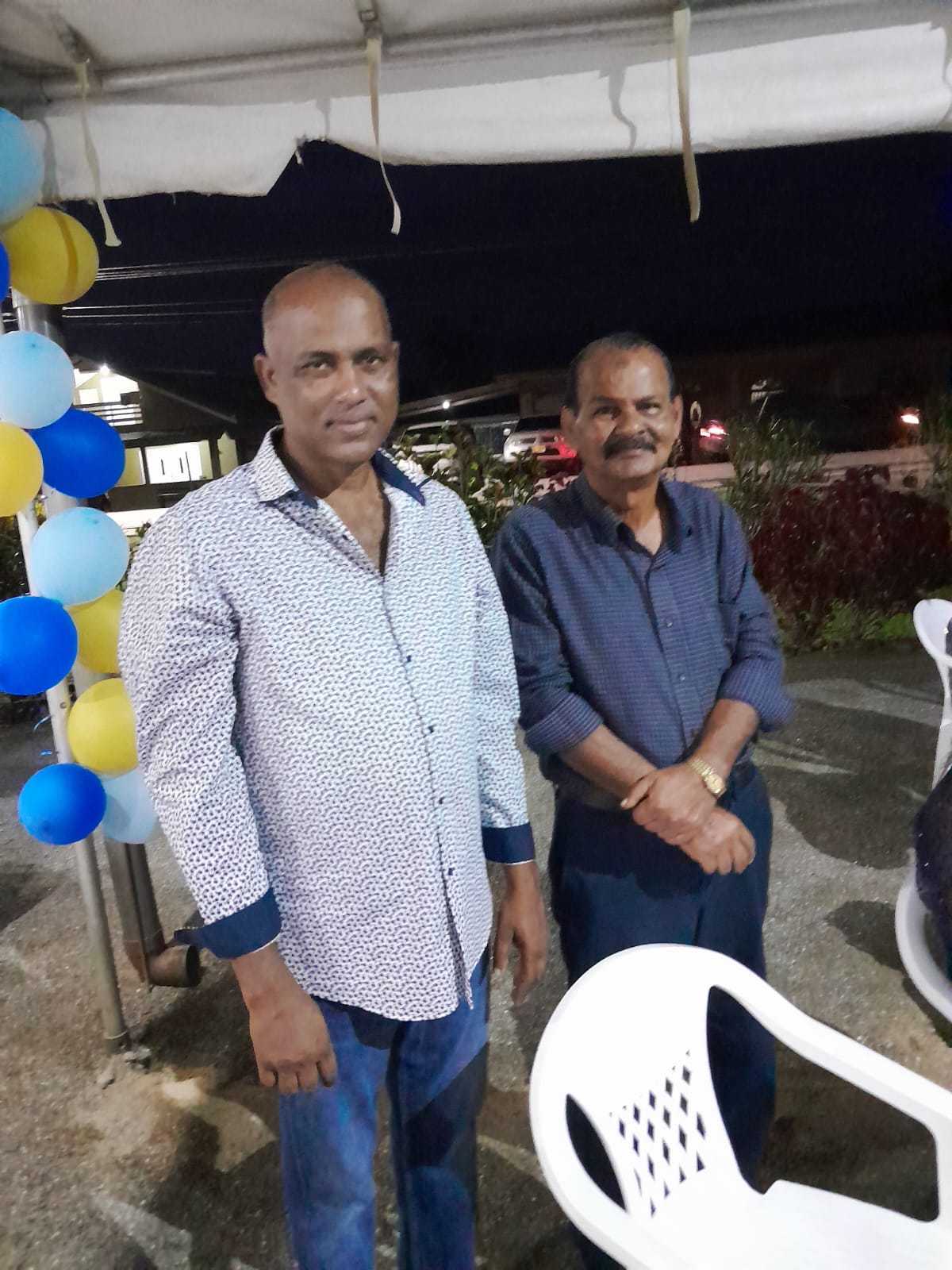 Mohamed Haroenkhan Abdul with a friend at an evening party