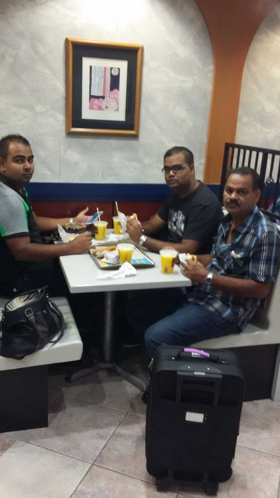 Mohamed Haroenkhan Abdul sharing a meal with his sons