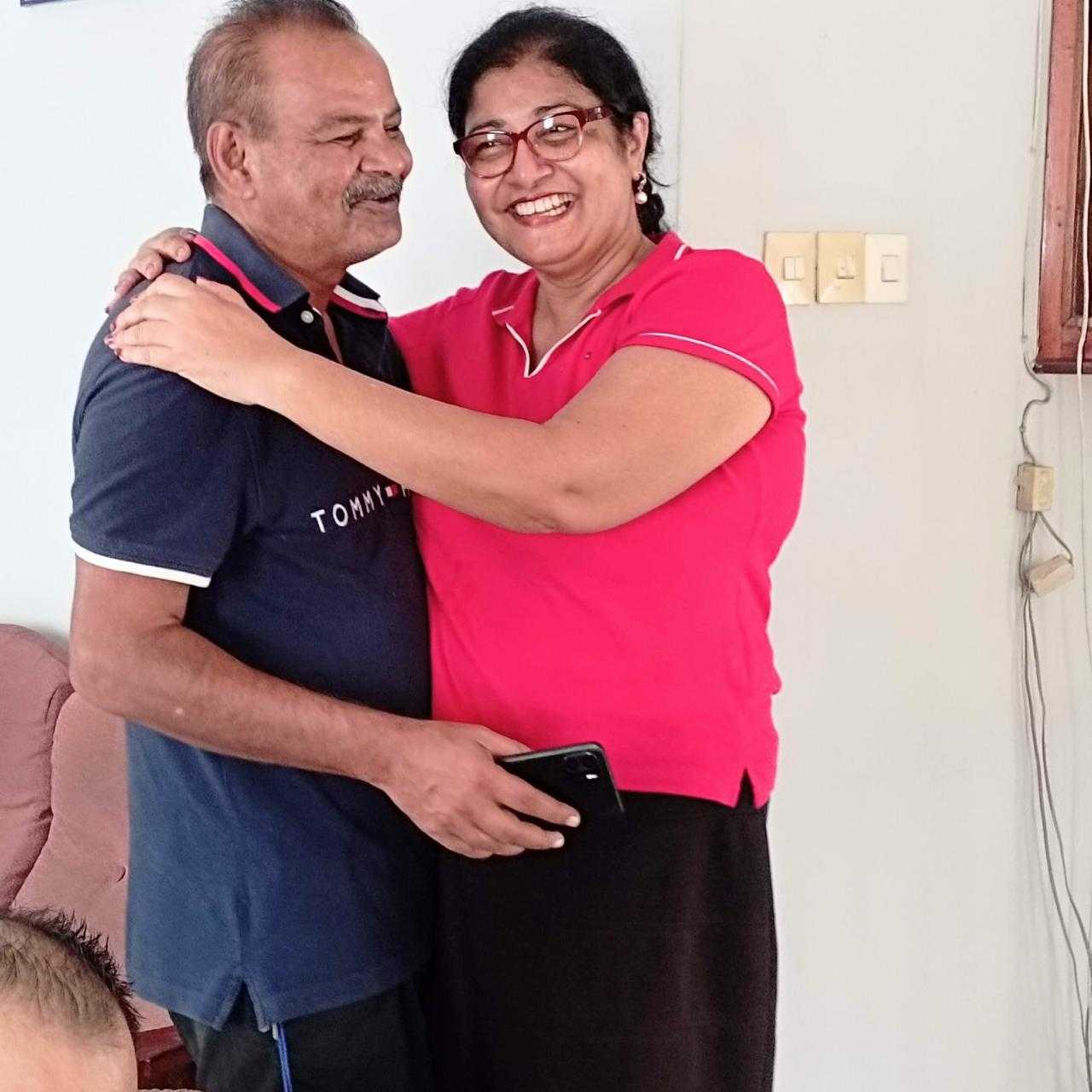 Mohamed Haroenkhan Abdul embracing his wife at home