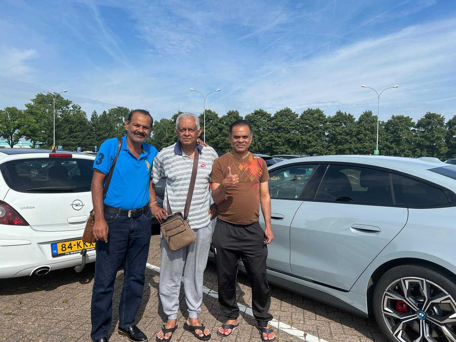 Mohamed Haroenkhan Abdul with family in a parking lot on a sunny day
