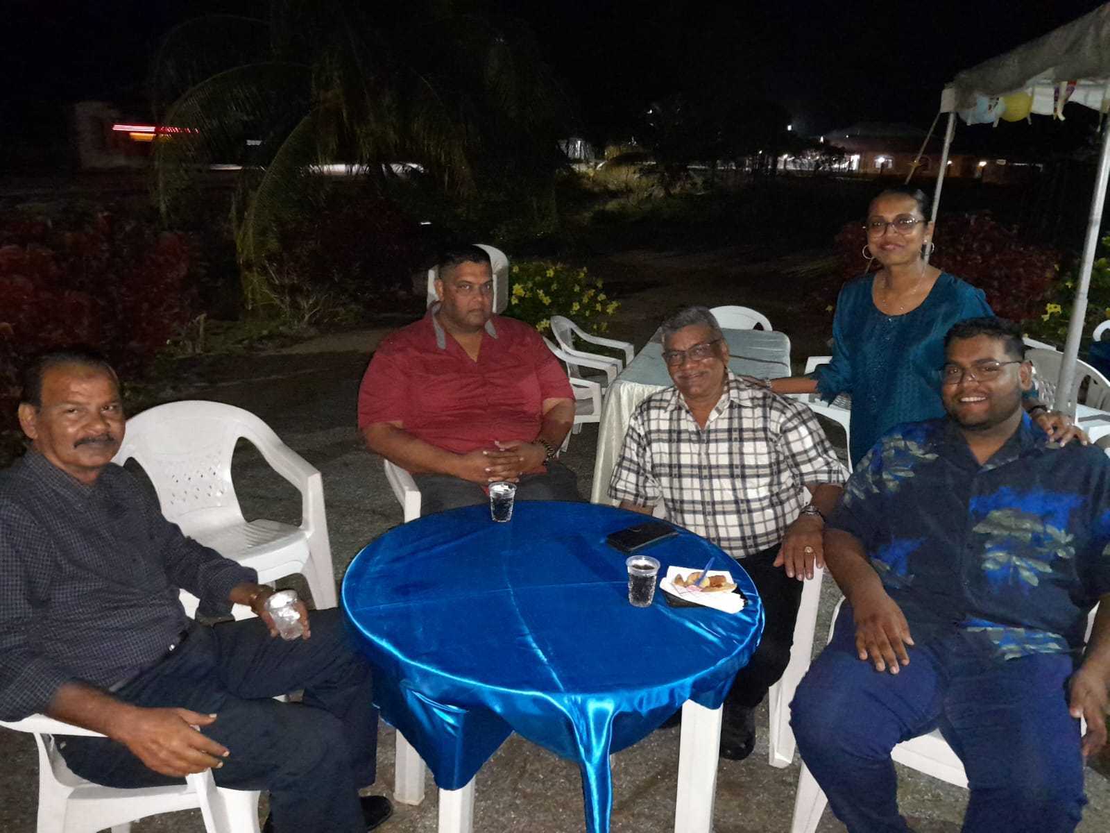 Mohamed Haroenkhan Abdul with family and friends at an evening gathering