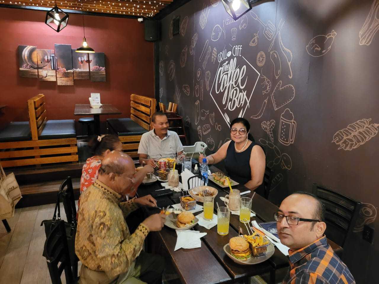 Mohamed Haroenkhan Abdul sharing a meal with family at a cafe
